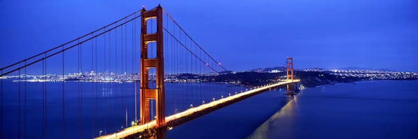 Golden Gate Bridge: Suspension bridge lit up at duskGolden Gate Bridge, San Francisco, California, USA by Panoramic Images