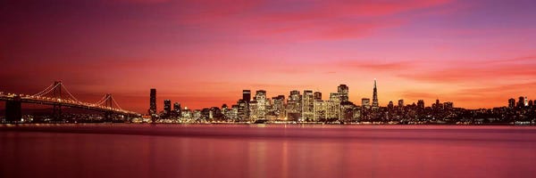 City Sunrises & Sunsets: Suspension bridge with city skyline at duskBay Bridge, San Francisco Bay, San Francisco, California, USA by Panoramic Images