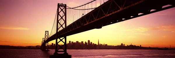 Ocean Sunrises & Sunsets: Bridge across a bay with city skyline in the backgroundBay Bridge, San Francisco Bay, San Francisco, California, USA by Panoramic Images