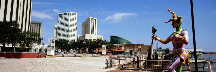 Jester statue with buildings in the background, Riverwalk Area, New Orleans, Louisiana, USA