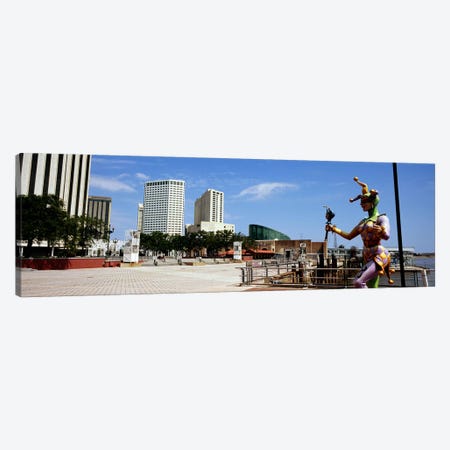 Jester statue with buildings in the background, Riverwalk Area, New Orleans, Louisiana, USA Canvas Print #PIM7897} by Panoramic Images Art Print