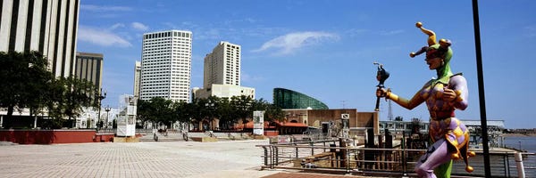 Jester statue with buildings in the background, Riverwalk Area, New Orleans, Louisiana, USA