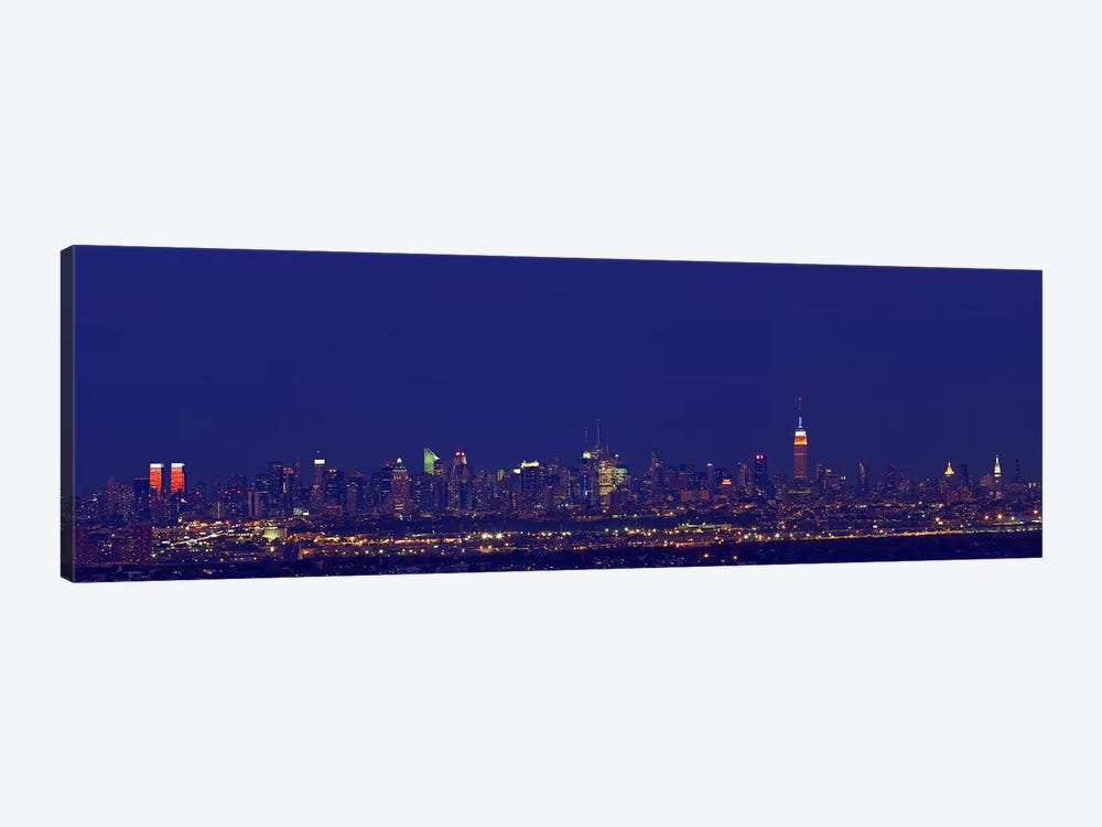 Buildings in a city lit up at night, New York City, New York State, USA by Panoramic Images 1-piece Art Print