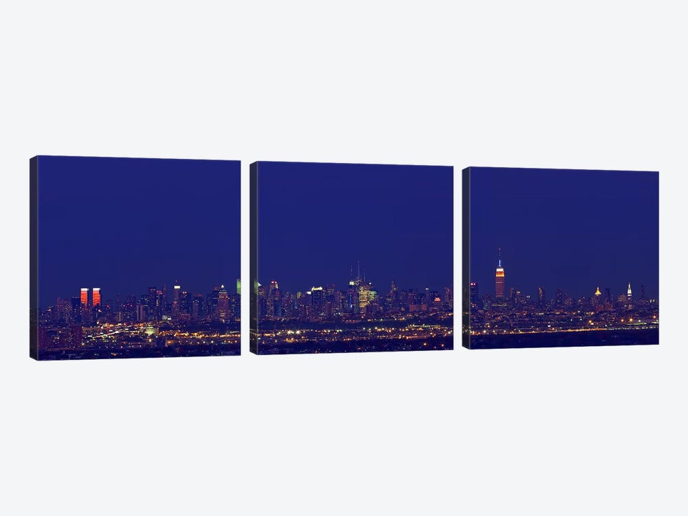 Buildings in a city lit up at night, New York City, New York State, USA by Panoramic Images 3-piece Art Print