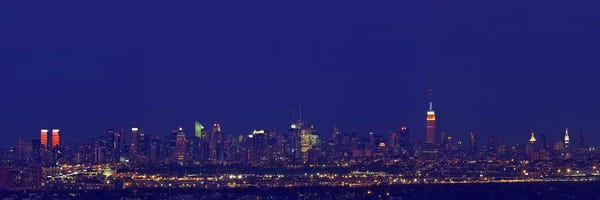 Buildings in a city lit up at night, New York City, New York State, USA