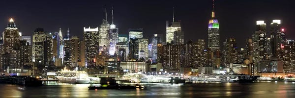 New York: Buildings in a city lit up at night, Hudson River, Midtown Manhattan, Manhattan, New York City, New York State, USA by Panoramic Images