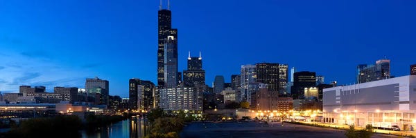 Chicago Skylines: Buildings in a city lit up at dusk, Chicago, Illinois, USA by Panoramic Images