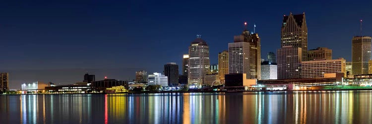 Buildings in a city lit up at dusk, Detroit River, Detroit, Michigan, USA by Panoramic Images wall art