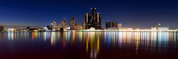Buildings in a city lit up at duskDetroit River, Detroit, Michigan, USA