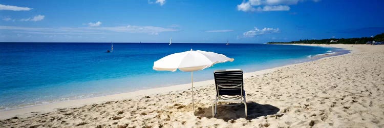 Single Beach Chair And Umbrella On Sand, Saint Martin, French West Indies