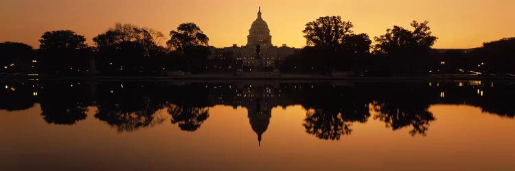 Reflection of a government building in water at duskCapitol Building, Washington DC, USA