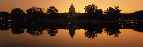 Reflection of a government building in water at duskCapitol Building, Washington DC, USA