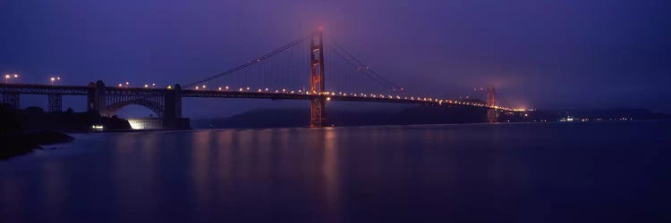 Suspension bridge lit up at dawn viewed from fishing pier, Golden Gate Bridge, San Francisco Bay, San Francisco, California, USA by Panoramic Images wall art