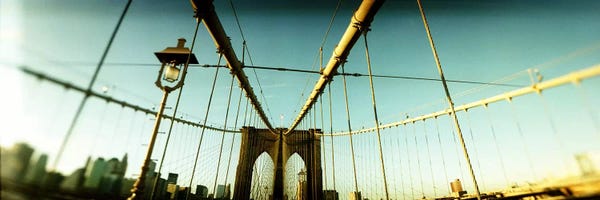 Brooklyn Bridge: Suspension bridge with a city in the background, Brooklyn Bridge, Manhattan, New York City, New York State, USA by Panoramic Images