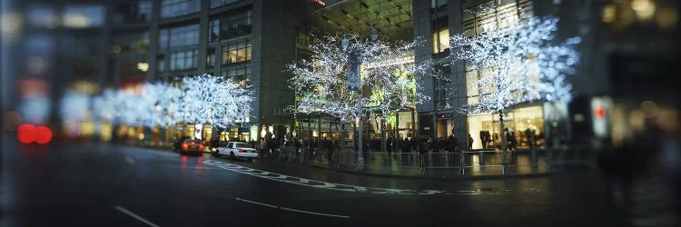 Buildings lit up at the roadsideColumbus Circle, New York City, New York State, USA