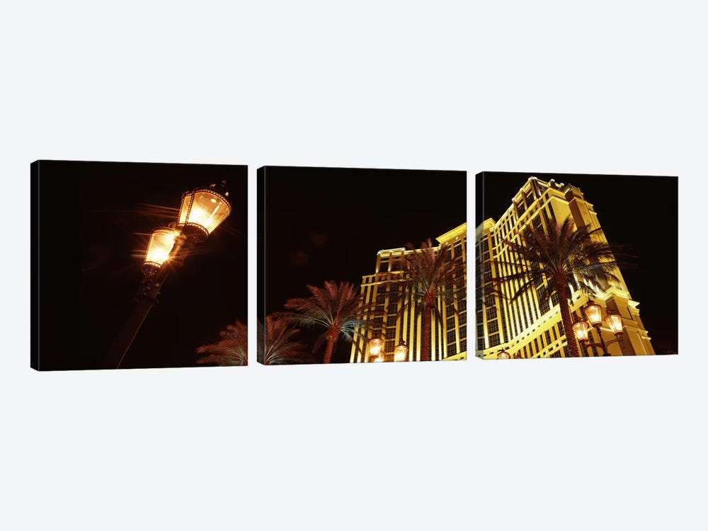 Low angle view of a hotel lit up at night, The Strip, Las Vegas, Nevada, USA by Panoramic Images 3-piece Canvas Print