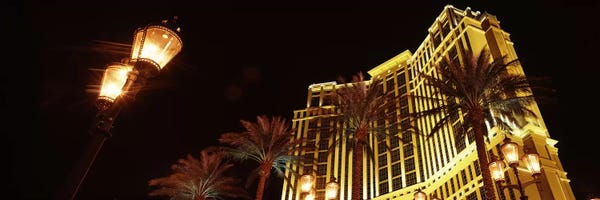 Nevada: Low angle view of a hotel lit up at night, The Strip, Las Vegas, Nevada, USA by Panoramic Images