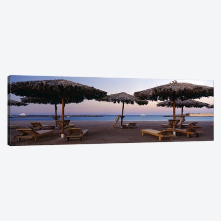 Lounge chairs with sunshades on the beach, Hilton Resort, Hurghada, Egypt Canvas Print #PIM8741} by Panoramic Images Canvas Artwork