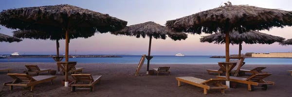 Egypt: Lounge chairs with sunshades on the beach, Hilton Resort, Hurghada, Egypt by Panoramic Images
