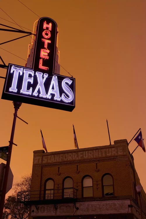 Low angle view of a neon sign of a hotel lit up at dusk, Fort Worth Stockyards, Fort Worth, Texas, USA