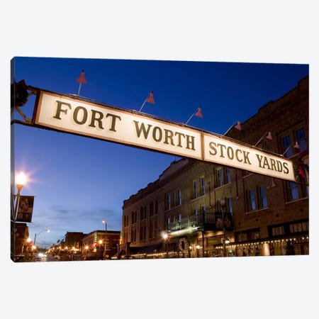 Signboard over a road at dusk, Fort Worth Stockyards, Fort Worth, Texas, USA Canvas Print #PIM8860} by Panoramic Images Art Print