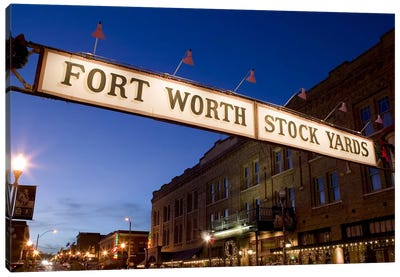 Signboard over a road at dusk, Fort Worth Stockyards, Fort Worth, Texas, USA Canvas Art Print