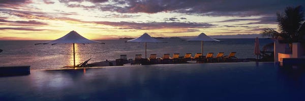 Fiji: Lounge chairs and patio umbrellas at a tourist resort, Matamanoa Island Resort, Mamanuca Islands, Fiji by Panoramic Images