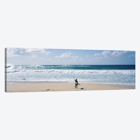 Surfer standing on the beachNorth Shore, Oahu, Hawaii, USA Canvas Print #PIM9054} by Panoramic Images Canvas Artwork