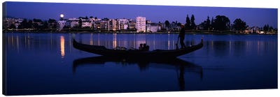 Boat in a lake with city in the background, Lake Merritt, Oakland, Alameda County, California, USA Canvas Art Print - Couple Art