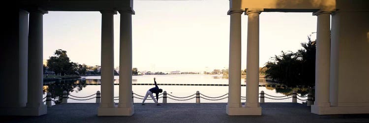 Person stretching near colonnade, Lake Merritt, Oakland, Alameda County, California, USA