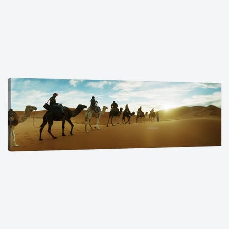 Tourists riding camels through the Sahara Desert landscape led by a Berber man, Morocco #2 Canvas Print #PIM9590} by Panoramic Images Canvas Artwork