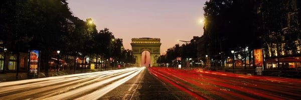 Arc de Triomphe: Blurred Motion View Of Nighttime Traffic On Avenue des Champs-Elysees Looking Toward Arc de Triomphe, Paris, France by Panoramic Images