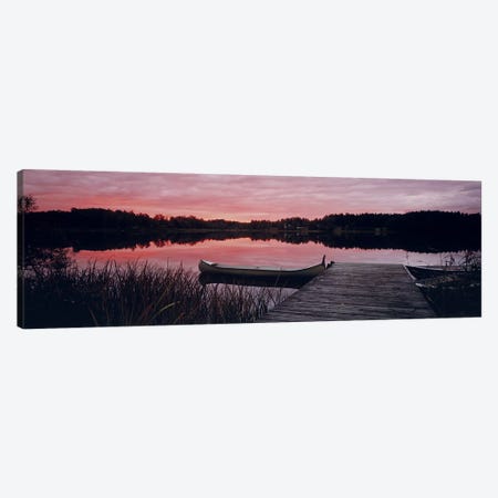 Canoe tied to dock on a small lake at sunset, Sweden Canvas Print #PIM9782} by Panoramic Images Art Print