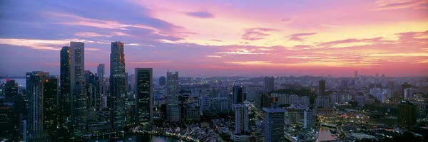 City Sunrises & Sunsets: High angle view of a city at sunset, Singapore City, Singapore by Panoramic Images