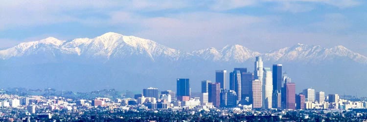 Buildings in a city with snowcapped mountains in the background, San Gabriel Mountains, City of Los Angeles, California, USA