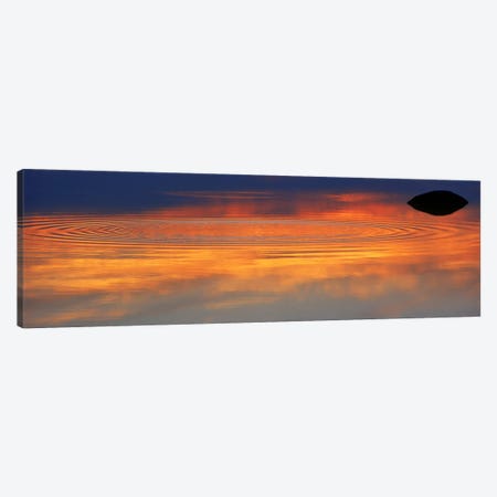 Reflection of clouds with circular ripples spreading outward across glassy lake waters at sunset Canvas Print #PIM9819} by Panoramic Images Art Print