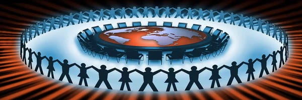 Circle of people around a table of world map