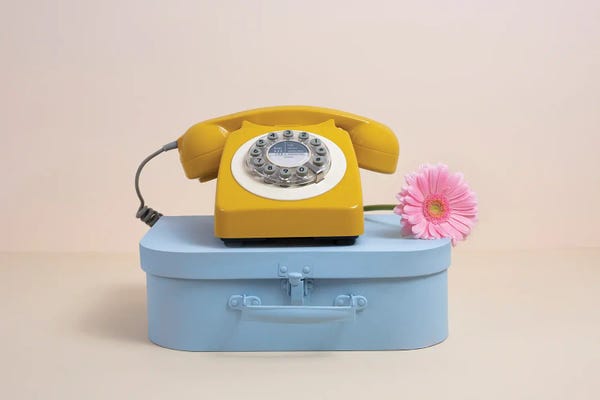 Still Life Photography: Blue Case And Yellow Phone With Flower by Pepino de Mar