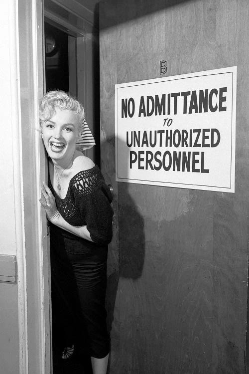 A Giggling Marilyn Monroe Peeking Out Of A Restricted Access Room