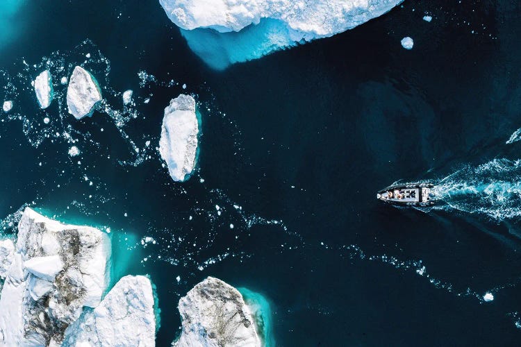 Small Boat Driving Through Huge Icebergs In Greenland