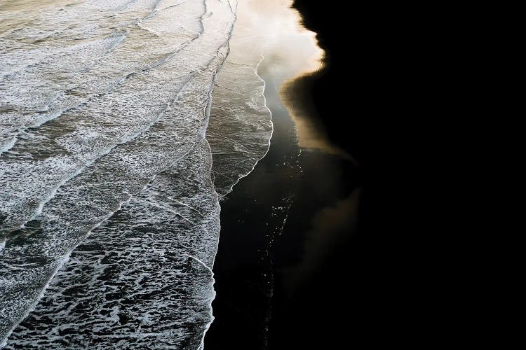 Minimal Waves Crashing On A Black Sand Beach In Iceland During Sunset