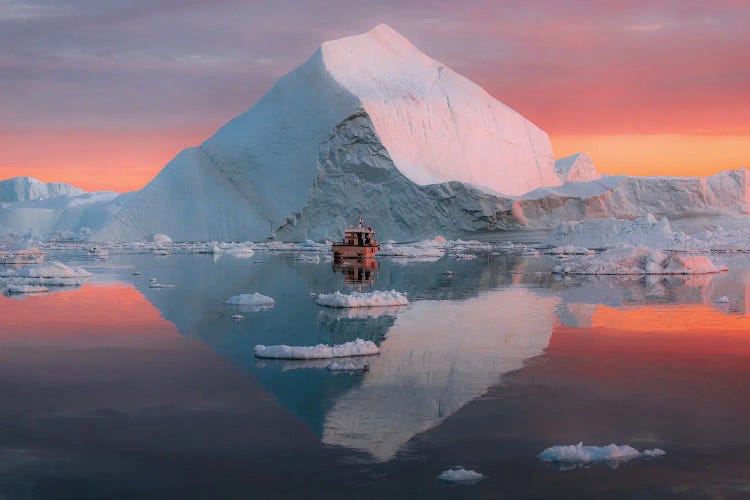 Lone Small Boat Floating In Front Of An Iceberg In Greenland During A Burning Sunset