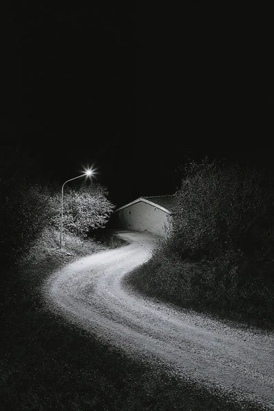 Michael Schauer: Minimalist Black And White Photograph Of The House At The End Of The Road At Night by Michael Schauer