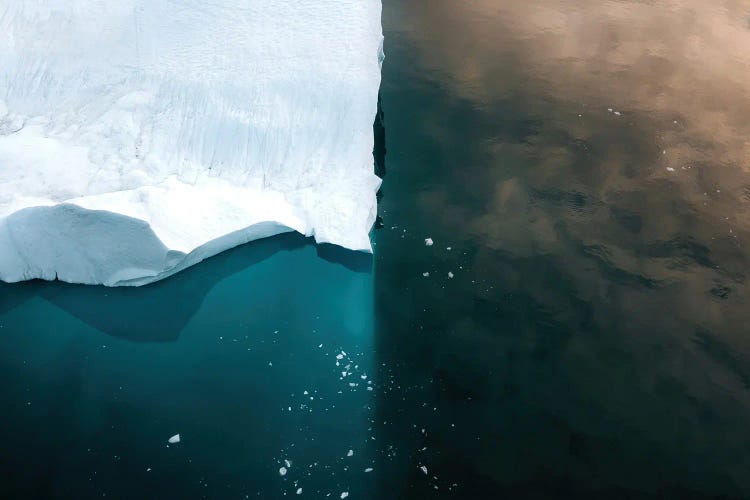 Iceberg Symmetry With Reflection Of The Sky In Greenland At Sunset