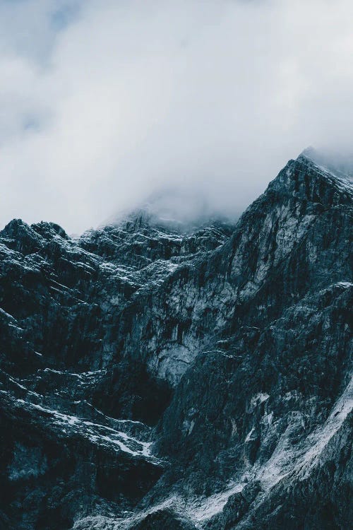 Majestic Mountain Peaks Shrouded In Clouds