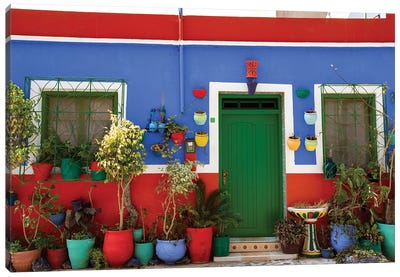 Asilah, Morocco. Multi-colored house with potted plants Canvas Art Print - Door Art