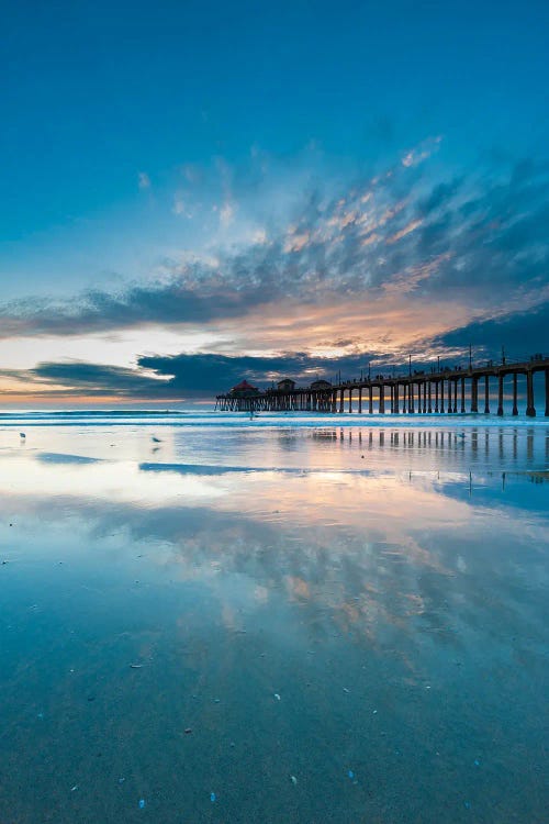 The Huntington Beach Pier And Reflections On The Wet Beach At Sunset. Huntington Beach, California.