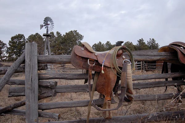 Nebraska: A Saddle Is Left Behind By Some Ranchers In The Nebraska Sandhills by Joel Sartore