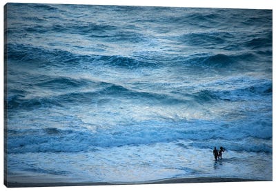 A Couple Plays In The Ocean Waves At Dusk At Riviera Beach Canvas Art Print - Joel Sartore