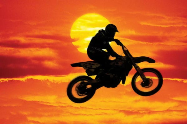 Action Shots: A Jumping Motocross Racer In Front Of The Sun by Steve Satushek